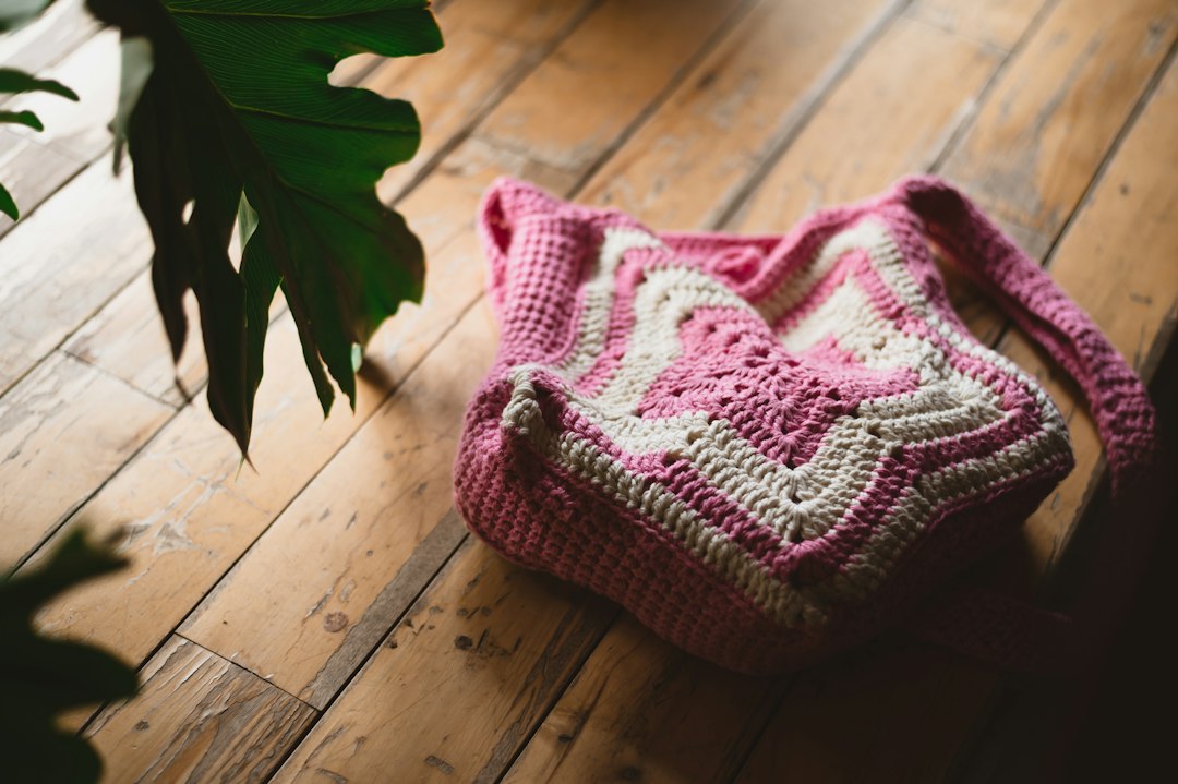 Pink and white crocheted handbag arranged as a boutique accessory photo